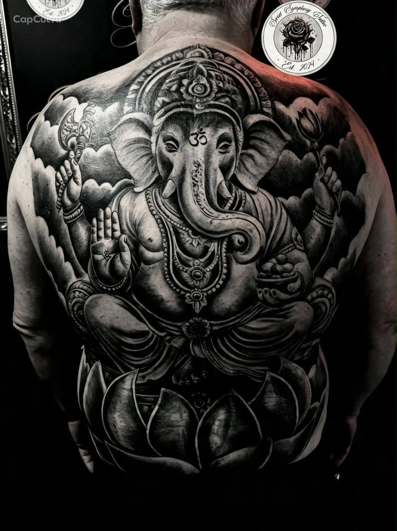 Black and grey realism full back cover-up tattoo of Ganesha by Sweet Symphony Tattoo