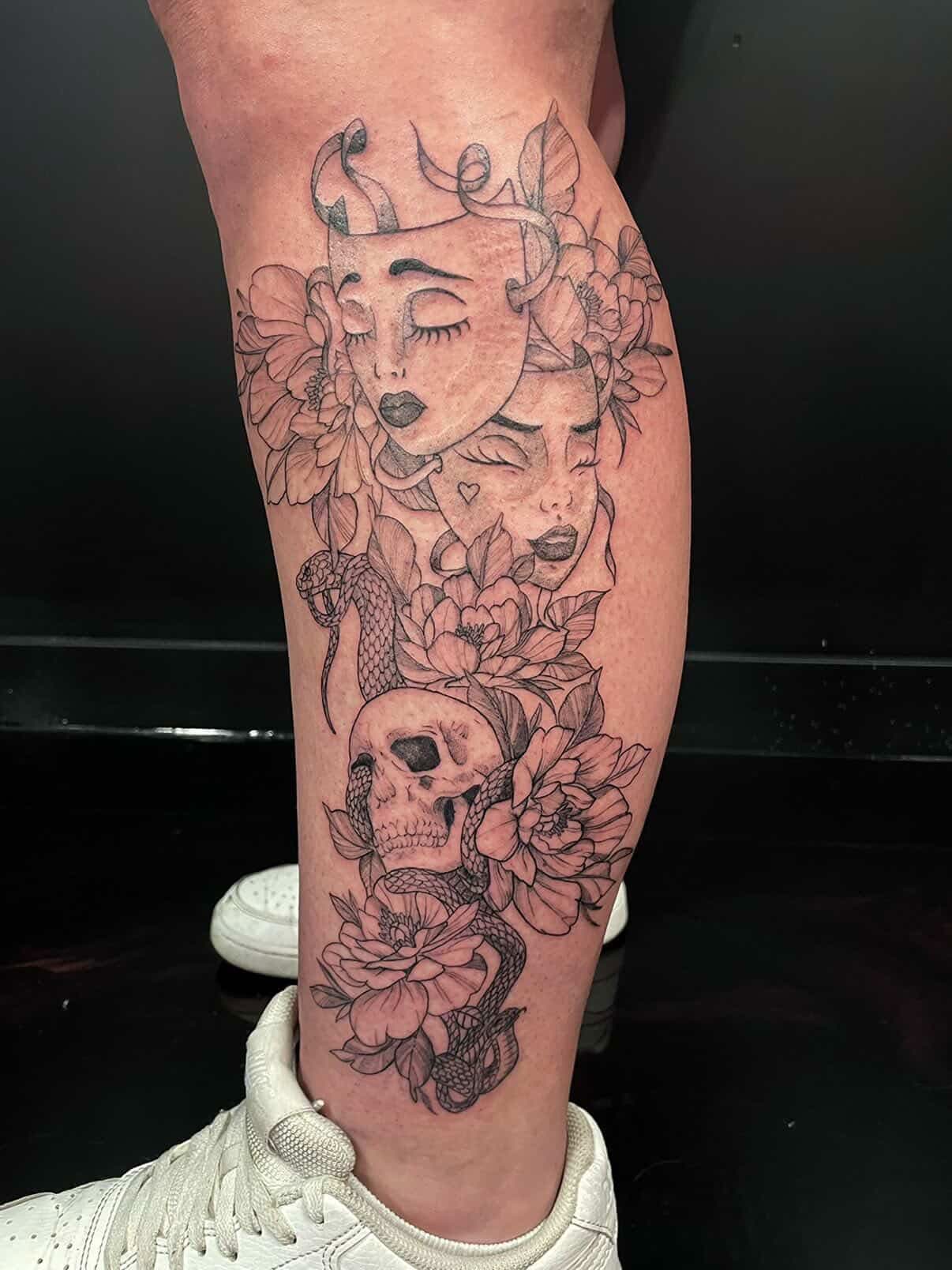 Dotwork realism tattoo combining two shaded women's face portraits, a skull, snake and flowers on the calf.