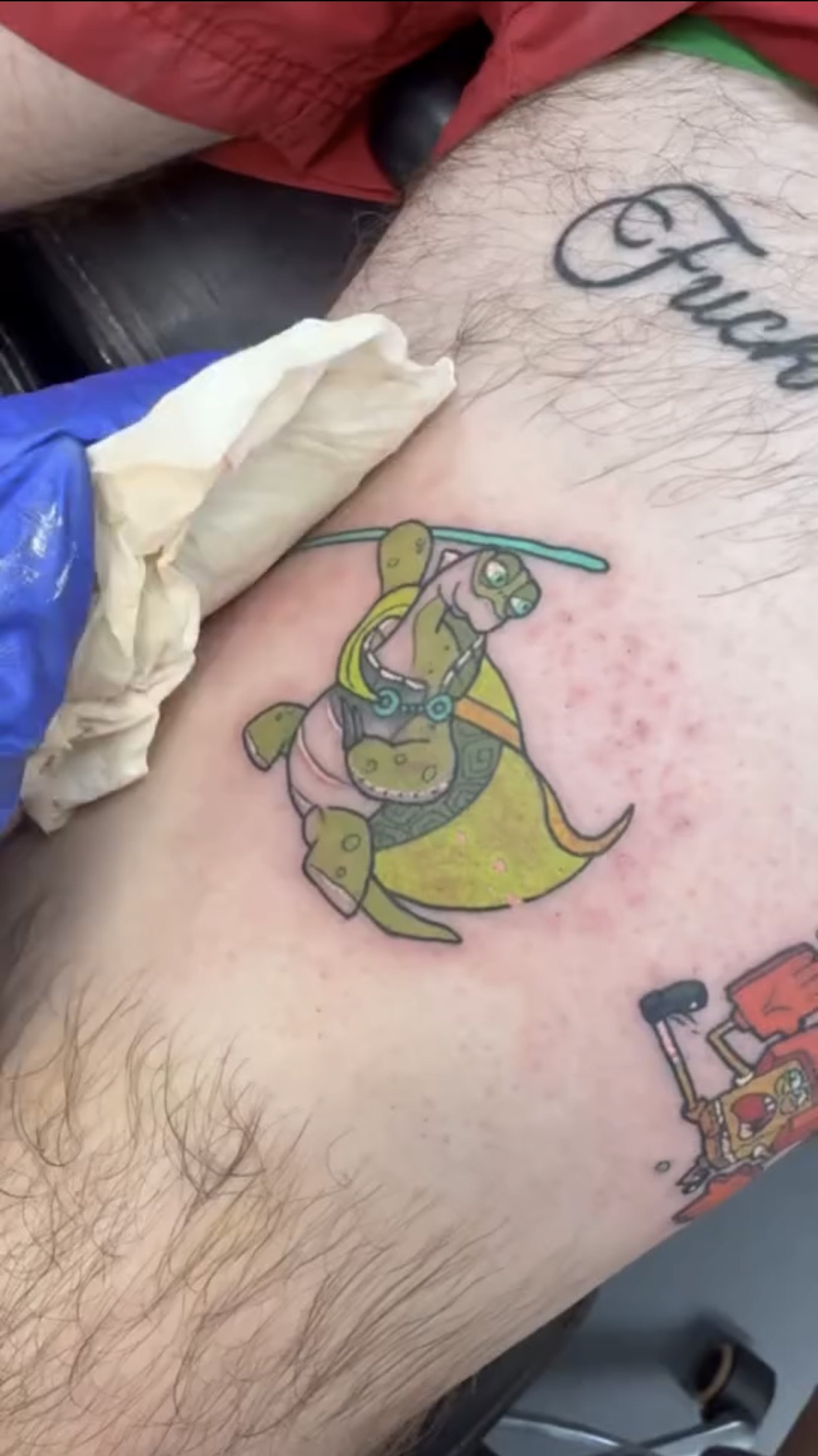 Small colour cartoon sea turtle tattoo in a bold traditional style.